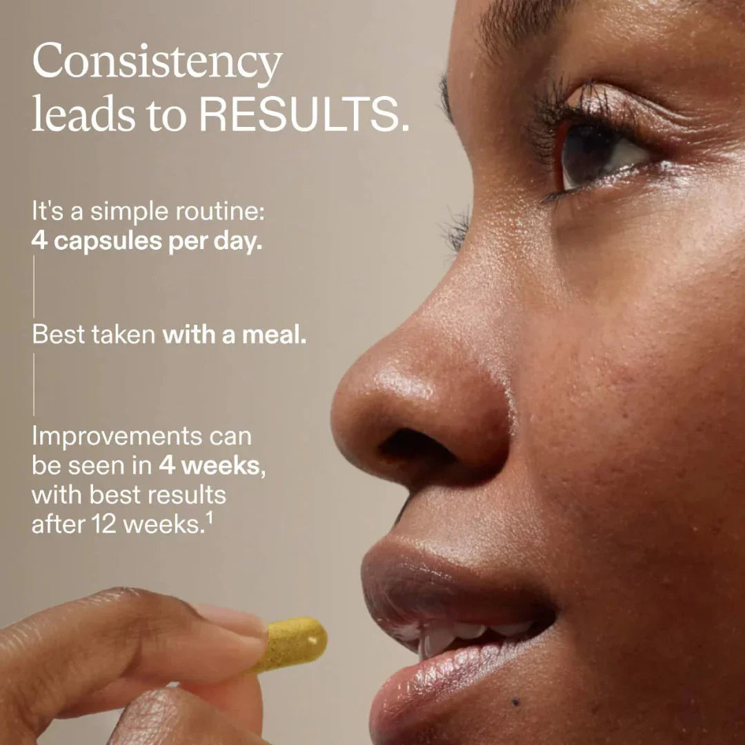 Person taking a supplement capsule with text about consistency leading to results on a beige background